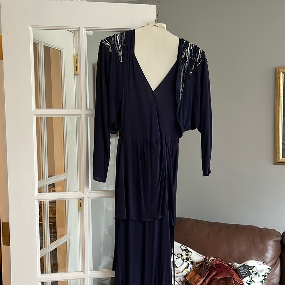 One piece navy blue jersey dress with built in bolero type jacket. Size small